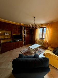 a living room with a couch and a table at Relax a Saint-Christophe in Saint-Christophe