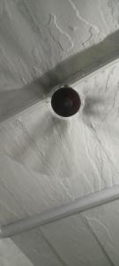 a ceiling with a light on top of it at Hotel Radhe in New Delhi