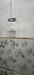 a electrical outlet with flowers on a wall at Hotel Radhe in New Delhi