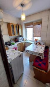 a kitchen with a counter and a table in it at South Gate of Bishkek in Bishkek