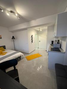 a bedroom with a bed and a kitchen with a sink at Lux City Stays-Beaumont Studio in Luxembourg