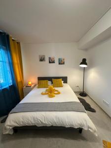 a teddy bear on a bed in a bedroom at Lux City Stays-Beaumont Studio in Luxembourg