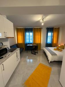 a kitchen and a bedroom with a bed in a room at Lux City Stays-Beaumont Studio in Luxembourg