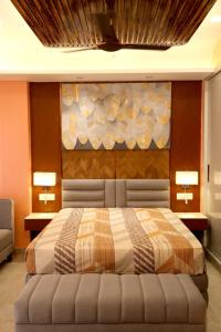 a bedroom with a bed with two lights on the wall at Aryan Home Stay Lucknow in Lucknow +12 photos