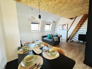 a living room with a dining table and a couch at Le Zen Kyoto in Lambersart