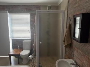 a bathroom with a toilet and a sink at Classic Air B&B in Pearly Beach +2 photos