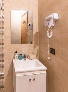 a bathroom with a white sink and a mirror at Marrakech Bloom Residence II in Oulad Akkou