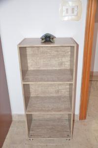a glass book shelf in a room at Taormina Bay Lucia's House 3 in Nizza di Sicilia