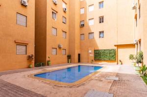 a swimming pool in front of a building at Marrakech Bloom Residence II in Oulad Akkou +11 photos
