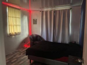 a bedroom with a bed and a red light at Chill House in San Antonio