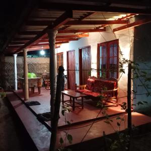 a living room with a couch and a table at Leeostar Homestay & Safari in Horuwila