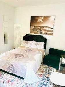 a bedroom with a large bed and a couch at Logan Cove Villa in Atlanta