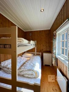 a bedroom with two bunk beds and a window at Spacious cabin in Hemsedal with sauna, near slopes in Hemsedal