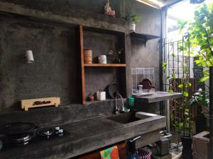 a kitchen with a sink and a counter top at Homestay Omah in Tabanan +2 photos