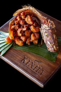 a plate of food with shrimp on top at Beachscape Kin Ha Villas & Suites in Cancún