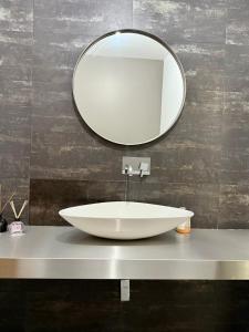 a bathroom with a white sink and a mirror at CASA Raiz in Ponta Delgada +10 photos