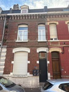 an old brick building with a car parked in front of it at Charmant Studio - Centre Douai - Netflix - 2 pers in Douai