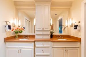 a bathroom with two sinks and two mirrors at Peace of Mind at Hound Ears in Valle Crucis +36 photos