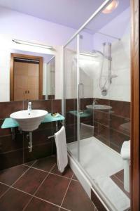 a bathroom with a glass shower and a sink at Regent Beachotel in Reggio di Calabria +20 photos