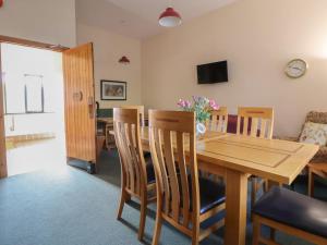 a dining room with a wooden table and chairs at Clwyd Special Riding Centre in Ffrith