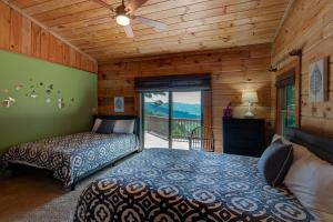 a bedroom with two beds and a balcony at 1 Sublime View in Boone