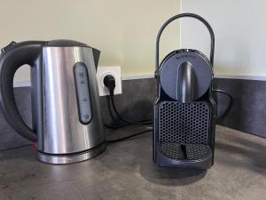 a coffee maker and a tea kettle on a counter at A l'orée des bois in Égat