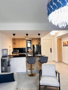 a kitchen with two chairs and a bar in a room at Edificio Oasis Apartamento 108 in Punta Cana