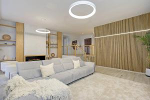 a living room with a couch and a fireplace at Home4u Mediterranean Sea Views Villa Alkaff in Manilva