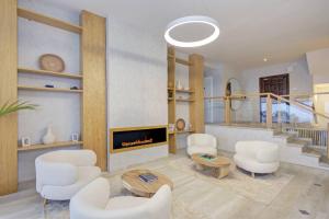 a living room with white chairs and a fireplace at Home4u Mediterranean Sea Views Villa Alkaff in Manilva +49 photos