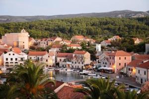 a town with a harbor with boats in the water at Villa Agava in Vrboska