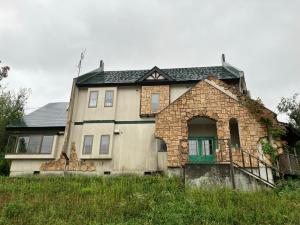 an old stone house with a green door at KijimaBase - Base 1 in Kijimadaira