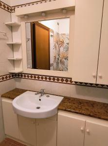 a bathroom with a sink and a mirror at BePlace La Nuvola in Rome +14 photos