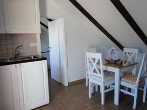 a kitchen with a sink and a table and chairs at Villa Agava in Vrboska