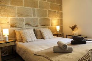 a bedroom with a large white bed with two lamps at Cozy Air-Conditioned - Central - Close to Train Station in Brive-la-Gaillarde