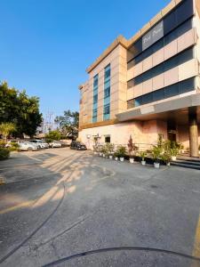 an empty parking lot in front of a building at Hotel Park Prime With Primmum Rooms in Haridwār