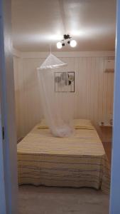 a bedroom with a bed with a net on it at Relaxing setting in harmony with nature in Le Moule