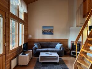 a living room with a couch and a table at Vuorsa 1 A 1 in Saariselka