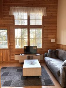 a living room with a couch and a coffee table at Vuorsa 1 A 1 in Saariselka