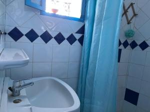 a bathroom with a toilet and a sink and a window at Dar Onsar in Chefchaouene +62 photos