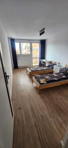 a room with several beds in a room at Apartament przy Starym Rynku in Poznań +16 photos