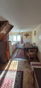 a living room with a table and a kitchen at Sojka in Divčibare