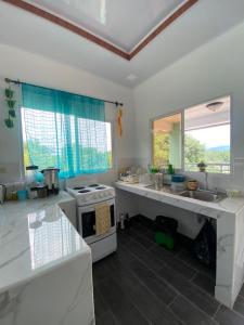 a kitchen with a sink and a stove at apartamento cerca de aguas termales in Gracias +8 photos