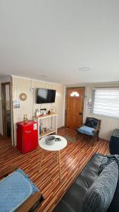 a living room with a couch and a table at Che Manuel in Puerto Natales