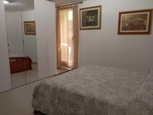a bedroom with a bed and a window and a mirror at Casa Iole in Monte Isola