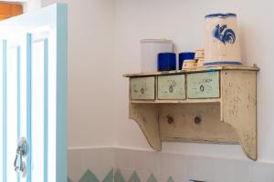 a shelf in a bathroom with some items on it at Relax nel Centro Storico in San Nicola Arcella +52 photos