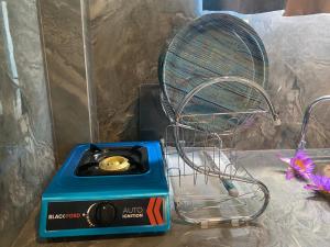 a blue electric fan sitting on top of a box at The Shore Residence in Hikkaduwa