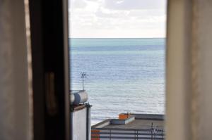 a view of the ocean from a window at Sunrise Hotel Cameria in Durrës