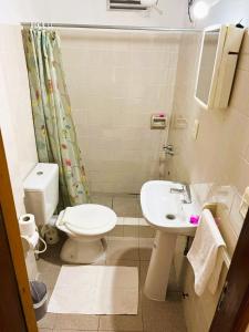 a bathroom with a toilet and a sink at Great central room Iguazu 1B in Puerto Iguazú +8 photos