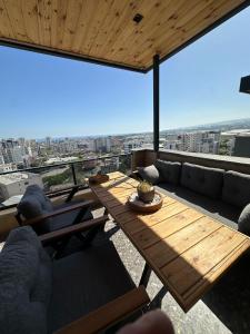 a living room with a wooden table and couch at Stylish Loft Apartment with Private Terrace in Erdemli