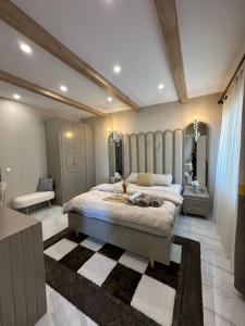 a bedroom with a large bed with a dog laying on it at Stylish Loft Apartment with Private Terrace in Erdemli